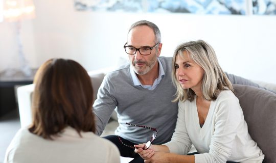 Senior couple meeting financial adviser for investment